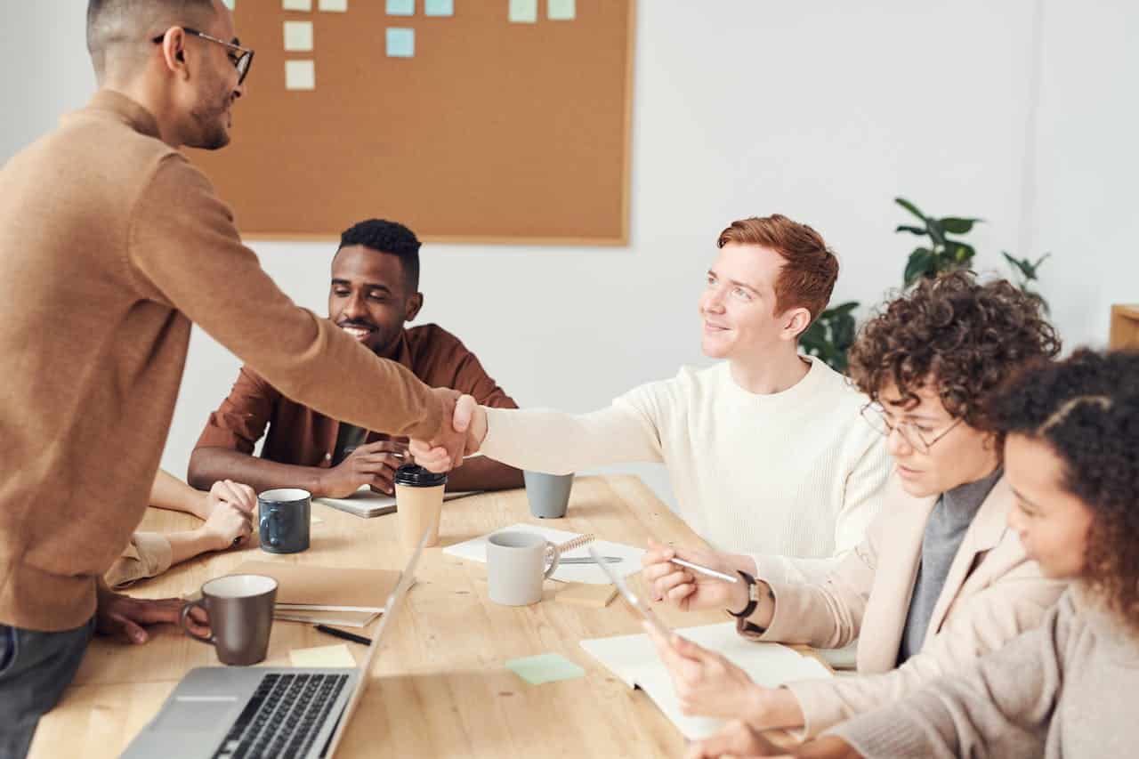 services-bg A diverse team in a modern office working together on a project, showcasing teamwork and collaboration.
